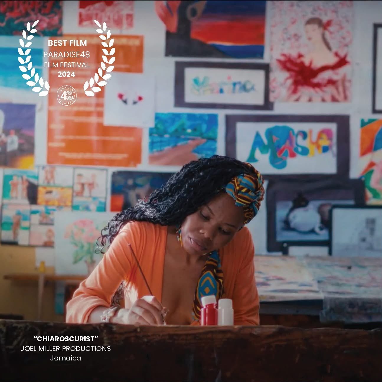 A woman paints at a desk in an art classroom in Chiaroscurist (2024), Best Film at Paradise48 Film Festival — cinematography by George Malcolm Walker