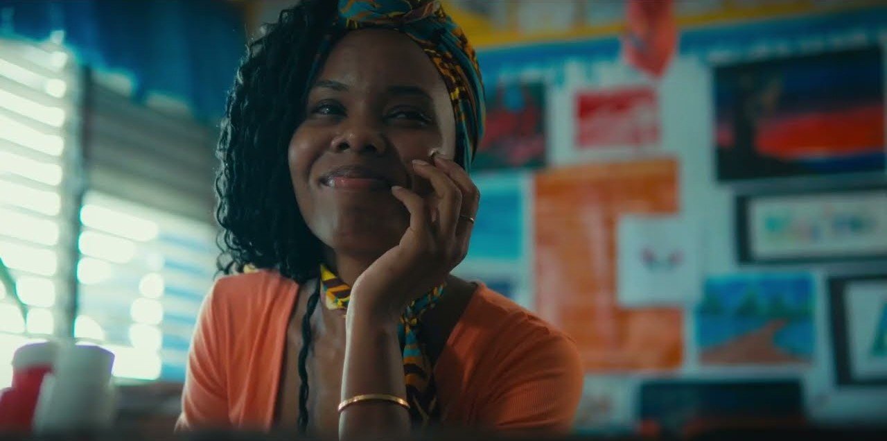 A teacher smiles in a classroom — frame from the cinematography reel of Jamaican director of photography George Malcolm Walker