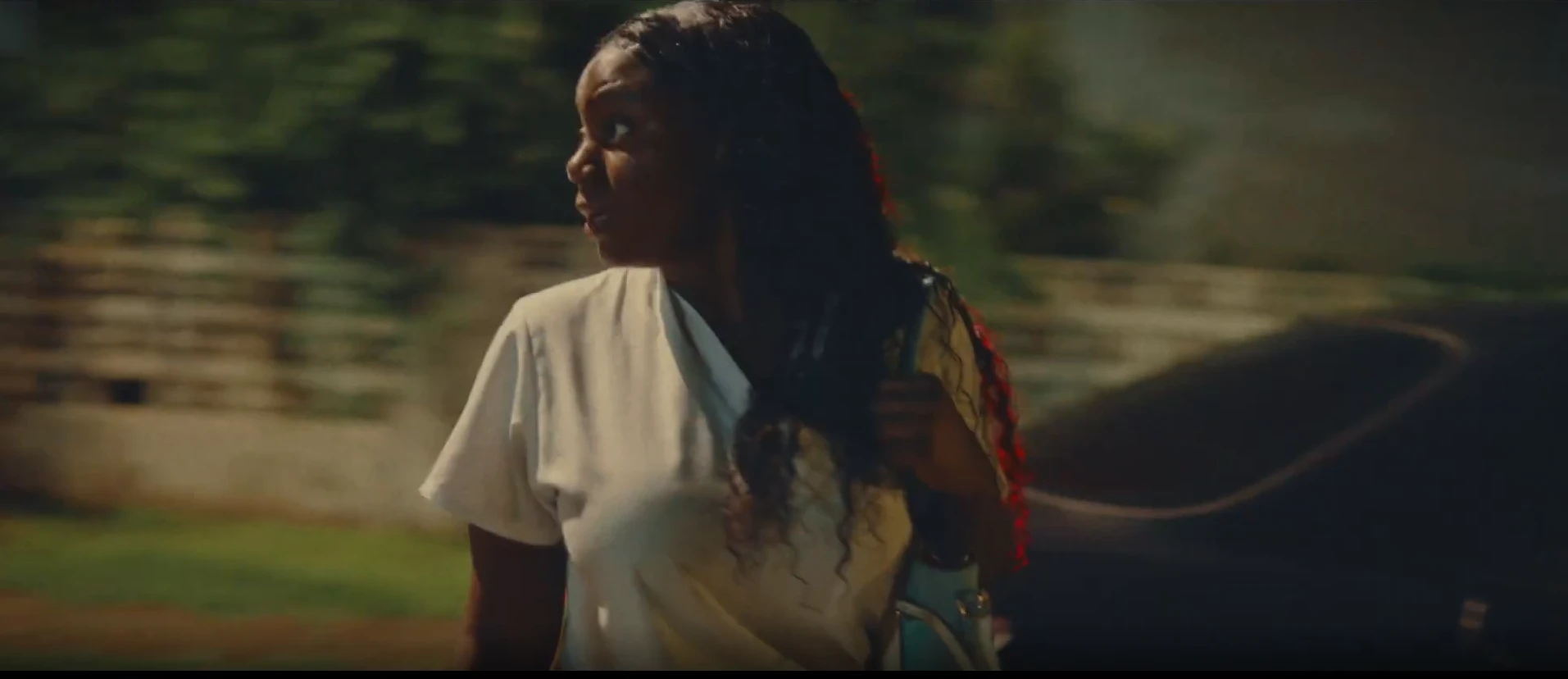 A woman in a white blouse glances back over her shoulder in LICK, a poetic documentary by George Malcolm Walker