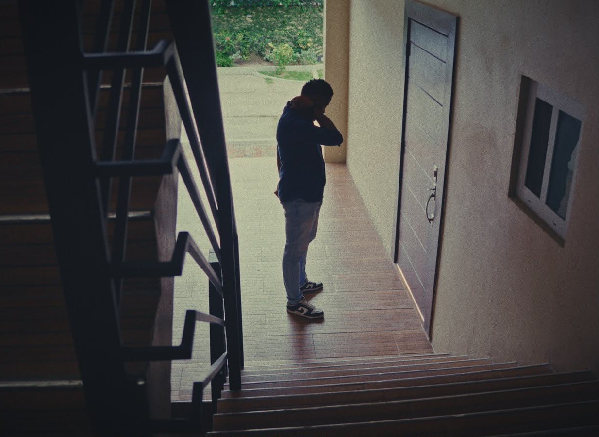 Still from Tangled Webs, a short film by Jamaican filmmaker George Malcolm Walker: a man alone at the foot of a stairwell